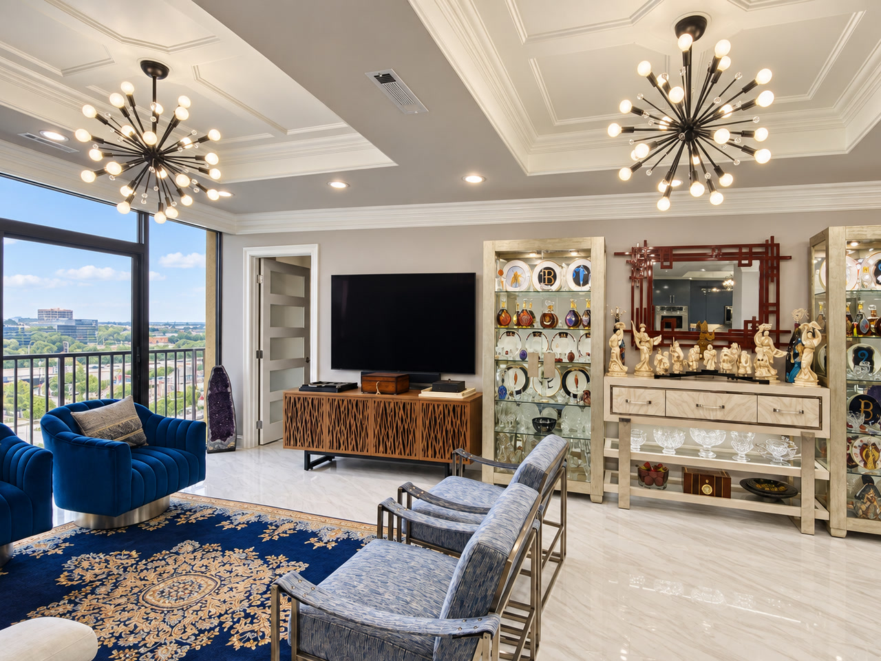 Sitting area with blue lounge seating, a patterned rug and city views