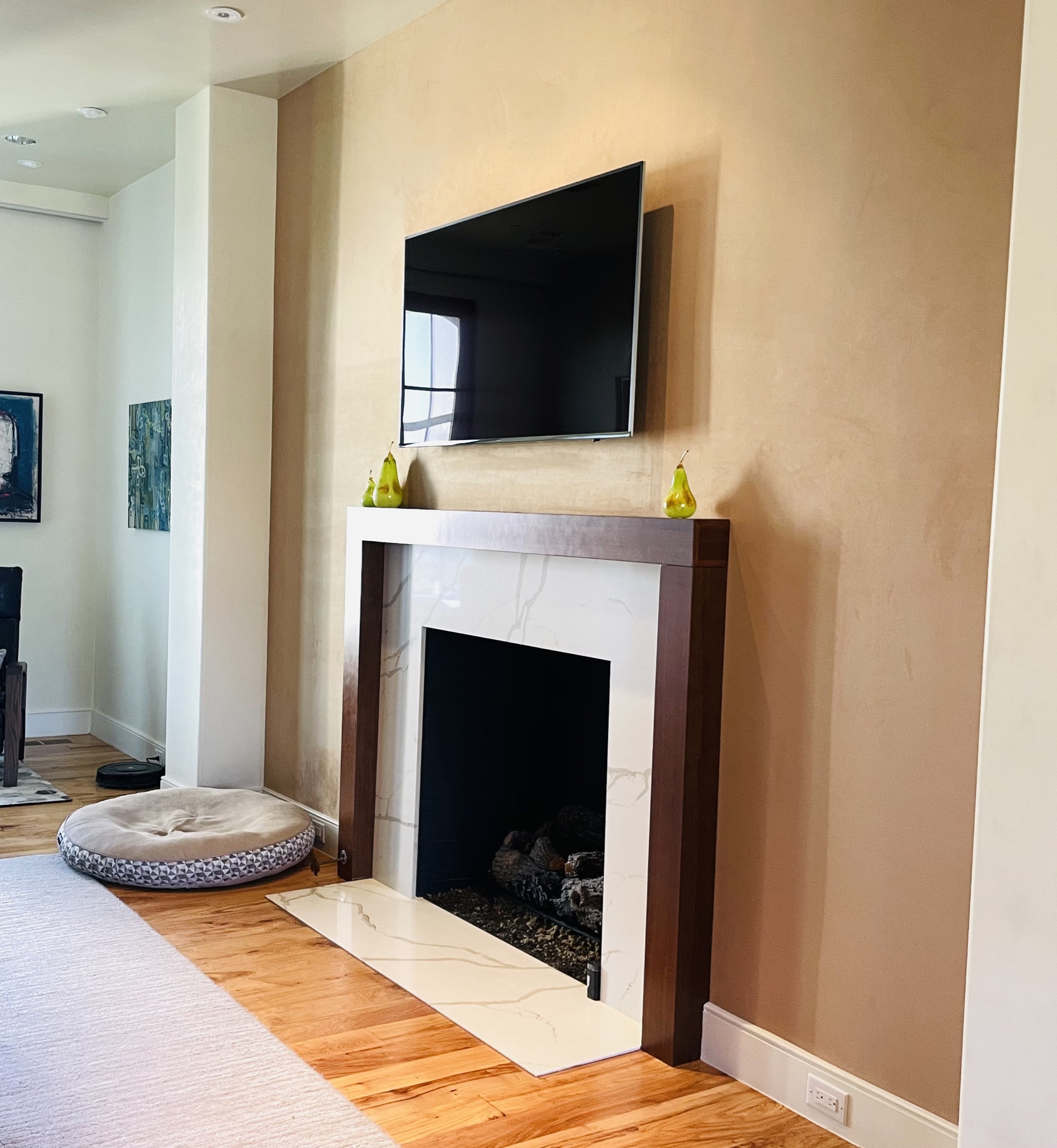 Modern fireplace with wood surround and a wall-mounted television