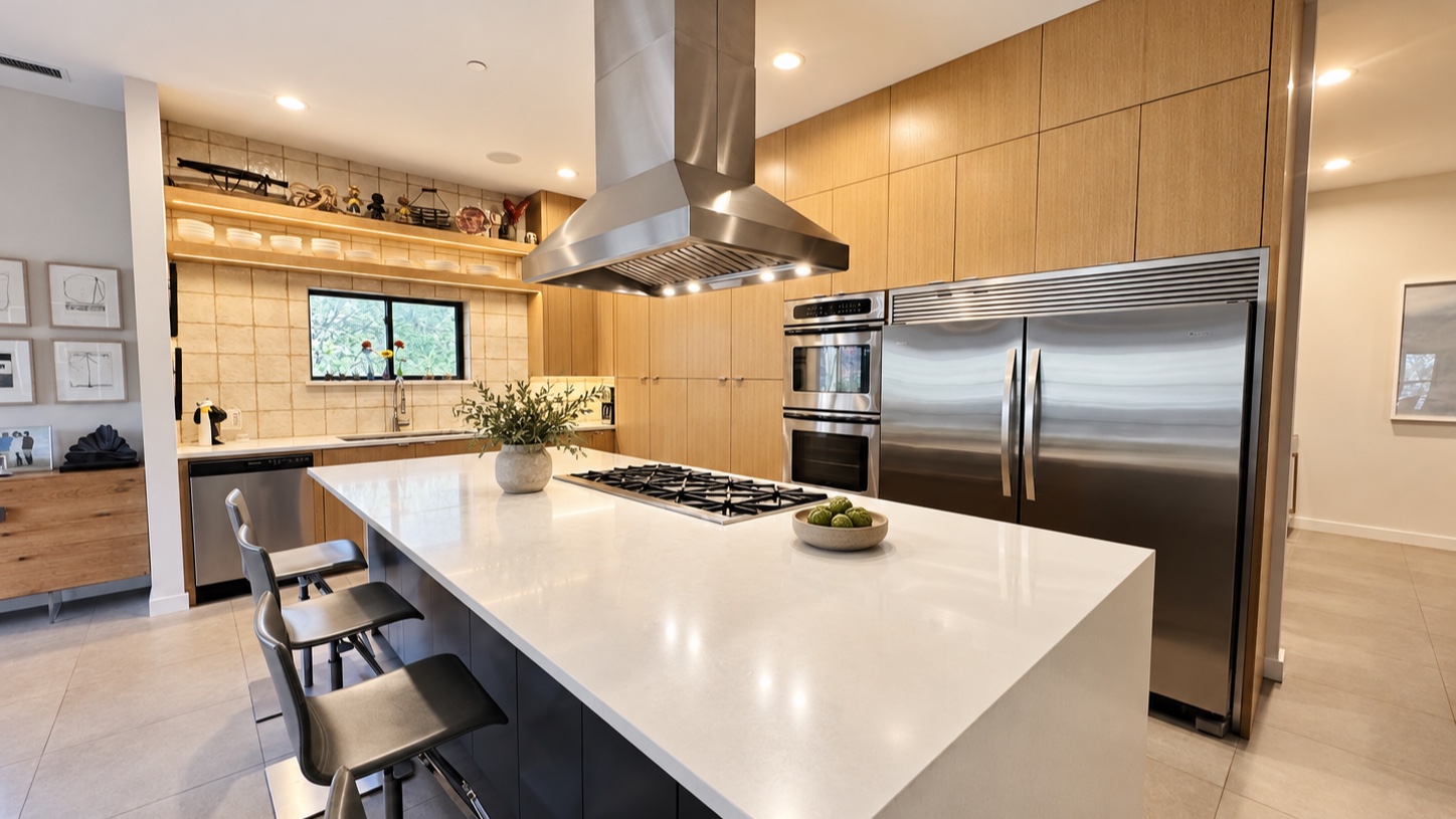 Warm wood kitchen with a large white island and stainless appliances