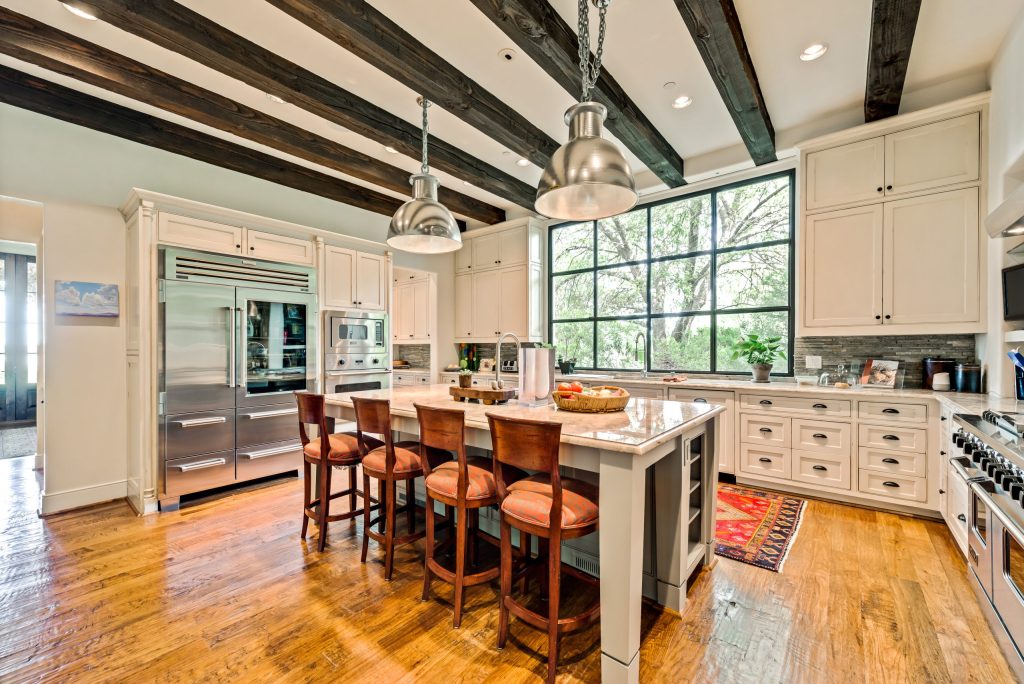 Homecorp kitchen remodel with exposed beams and a wall of windows