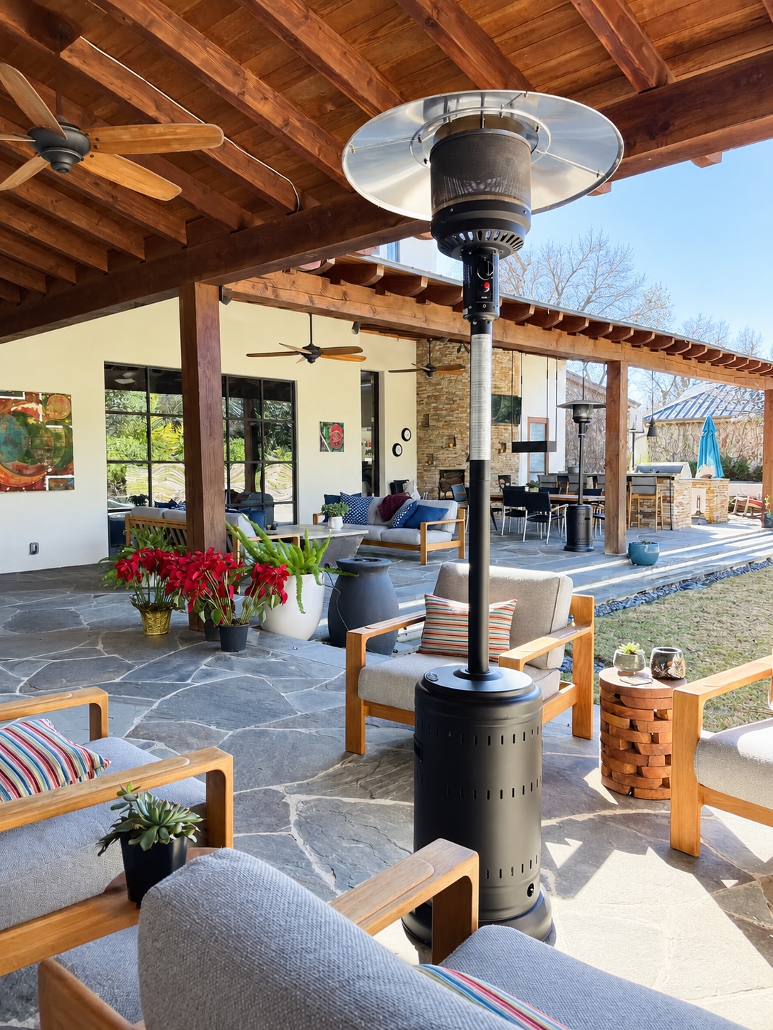 Covered wood-beam patio with outdoor seating, fireplace and dining area