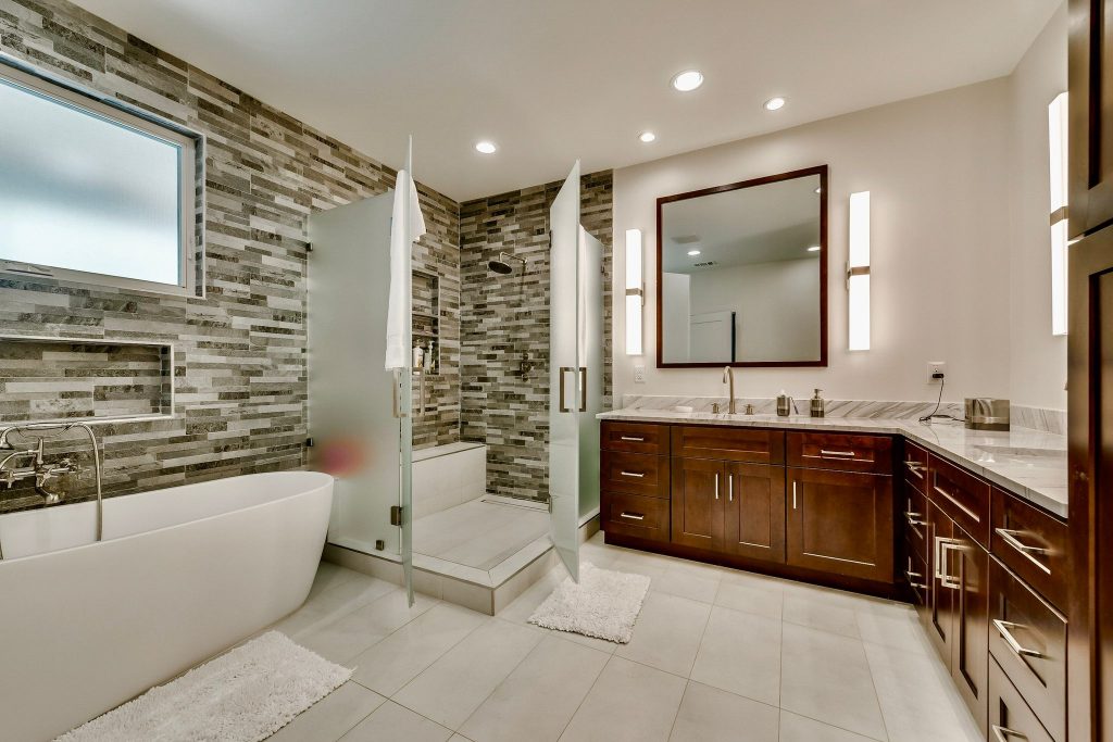 Bathroom with wood vanity and stone accent wall