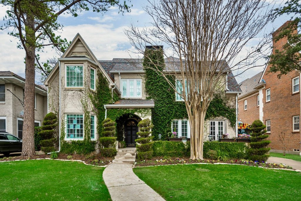 Traditional remodeled home exterior framed by trees