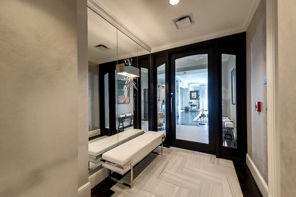 Modern entry with black-framed doors and bench