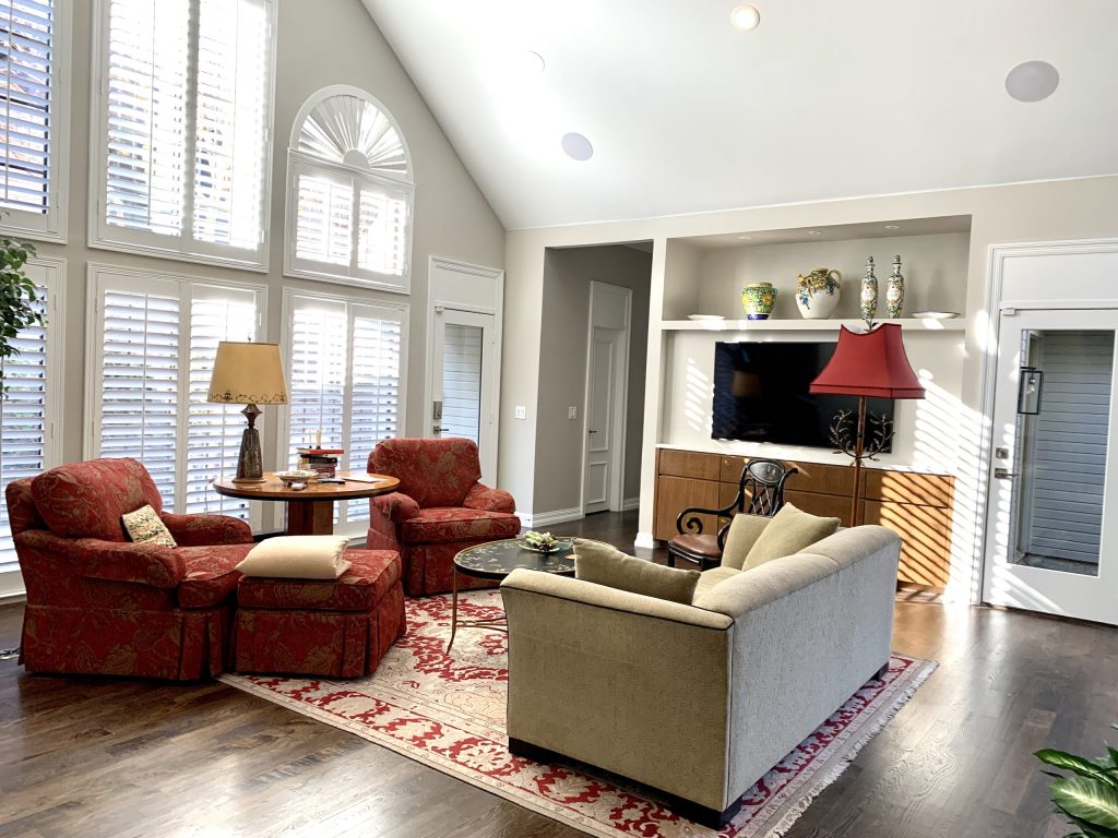 Living room with tall arched windows and layered furnishings