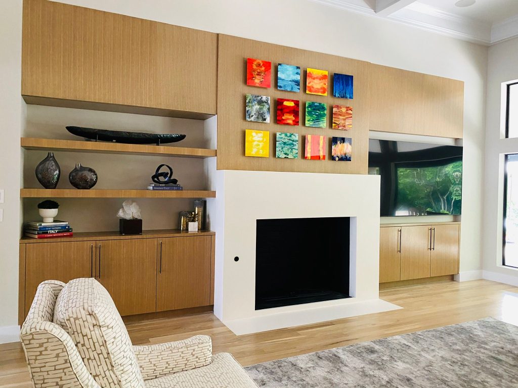 Living area with natural wood feature wall and colorful artwork
