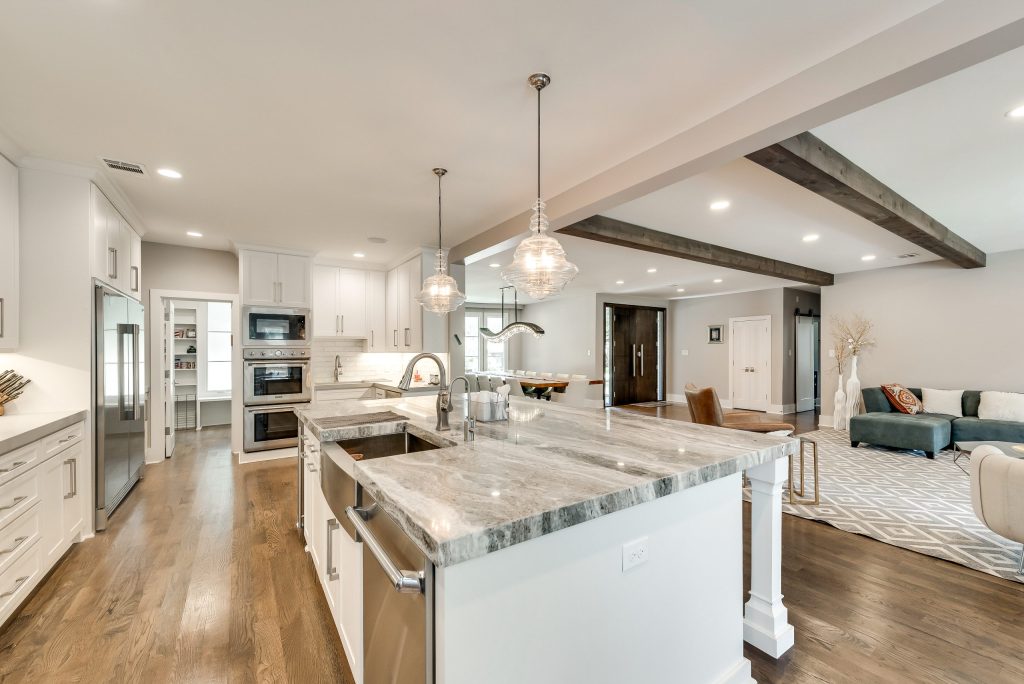 White kitchen with generous island and adjoining living area