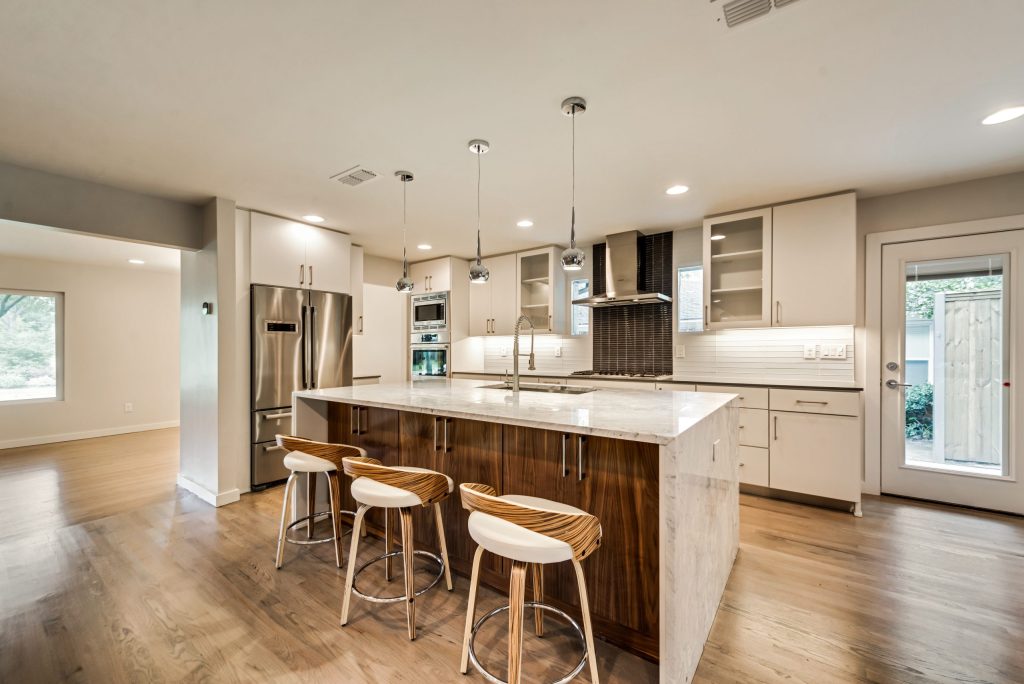 Kitchen with wood island and white cabinetry