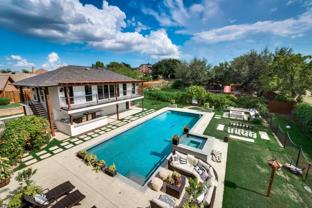 Expansive backyard with a swimming pool and lawn