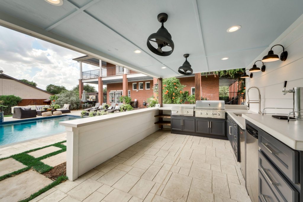 Covered outdoor kitchen with grill and counter seating