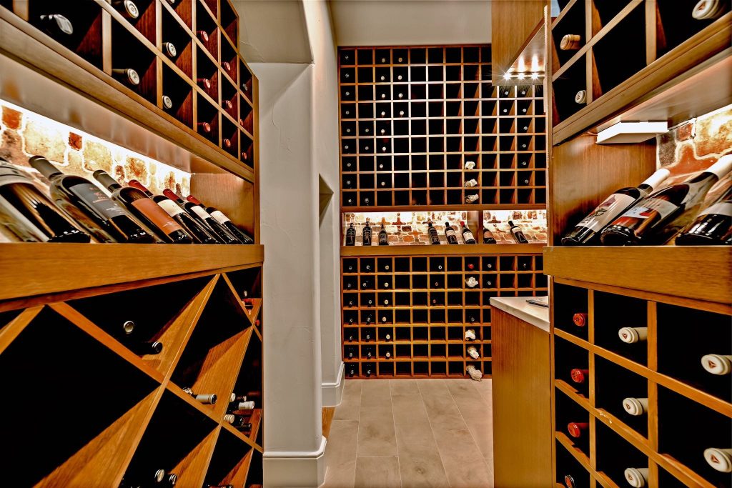 Wine cellar with custom wood racks on multiple walls