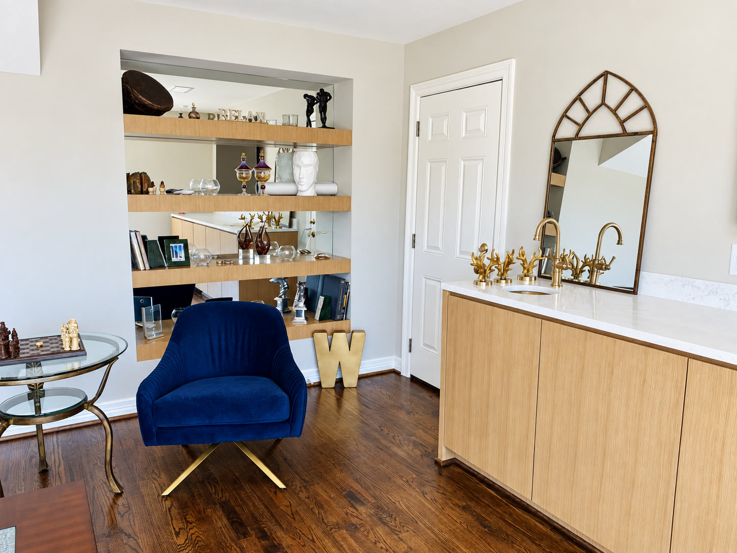 Wood and white bar cabinetry beside a blue lounge chair
