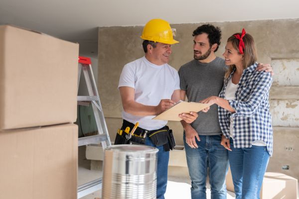 Contractor speaking with clients about the house.