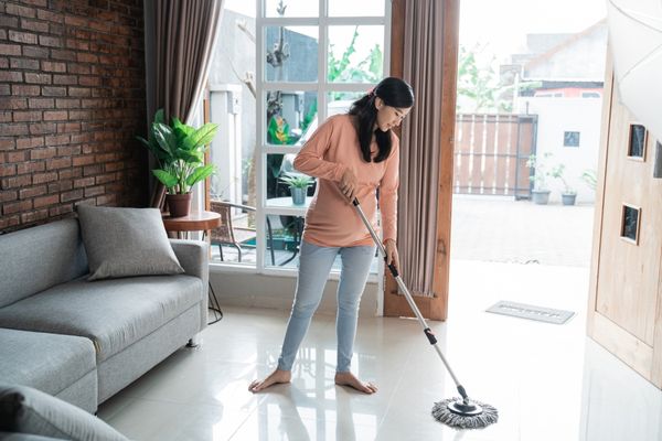 Woman doing daily household cleaning chores